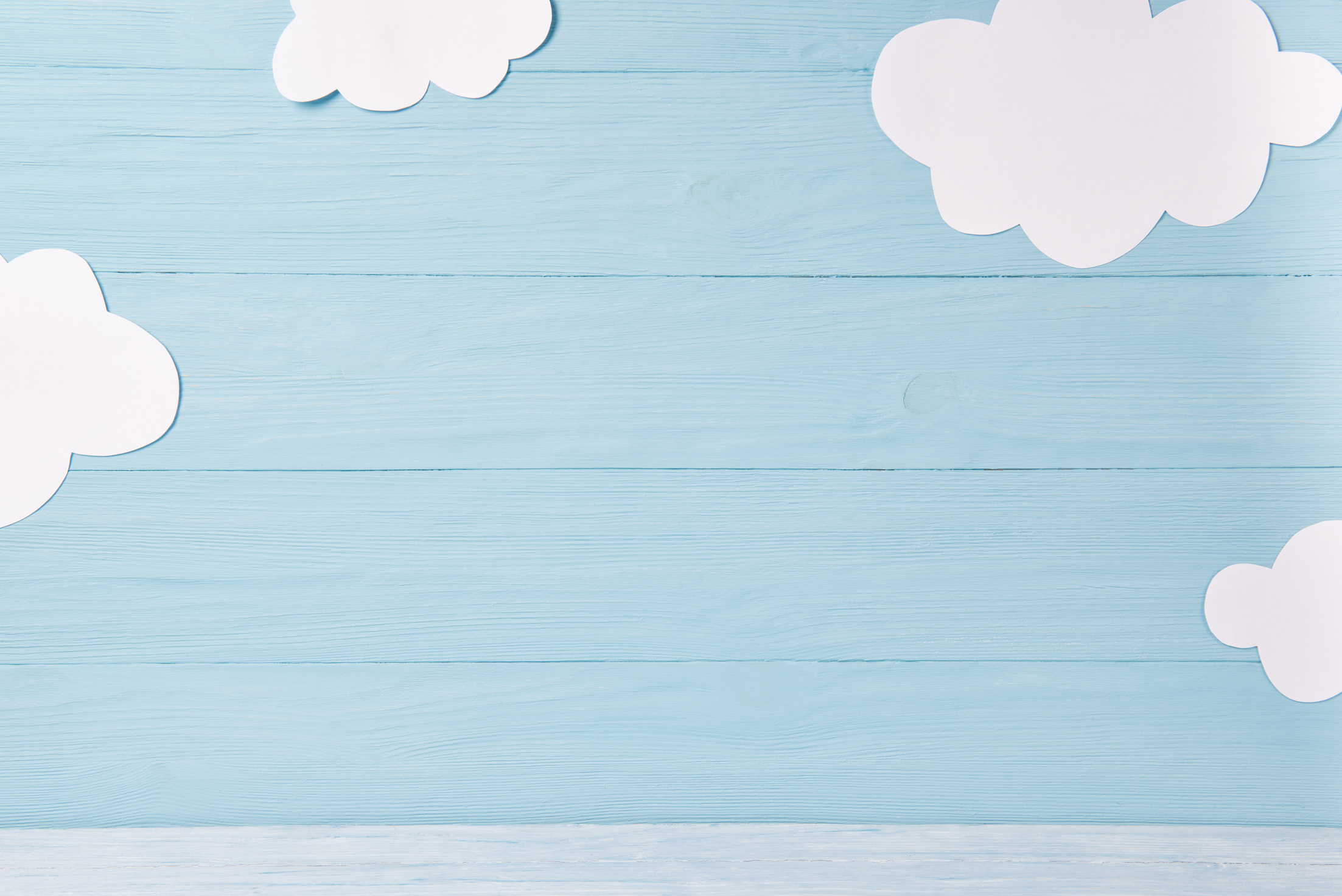 Cute children or baby background, white clouds on the blue wooden background